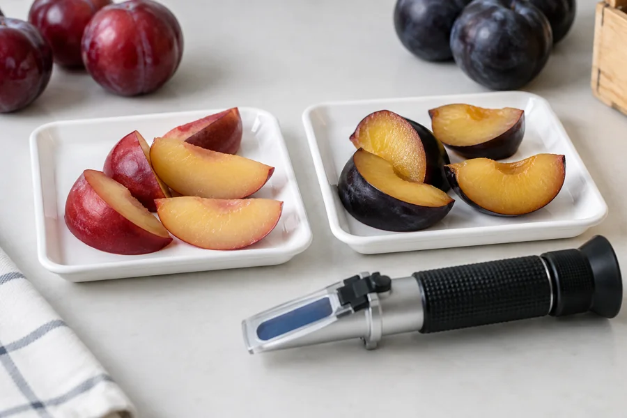 Red and dark plum sample trays with a refractometer